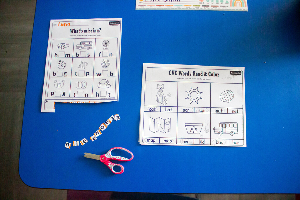 AES students cut out and glue in the missing vowels.