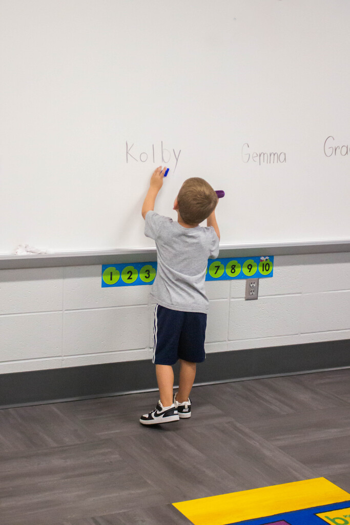 DES Preschool students practice spelling their name