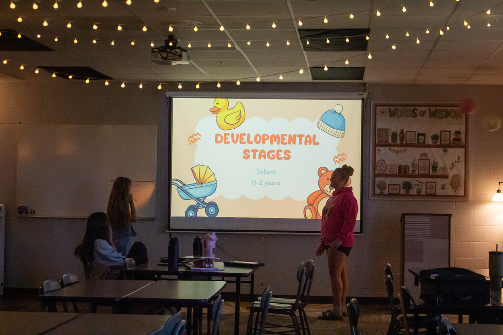 SDMS students present their research on child development stages.