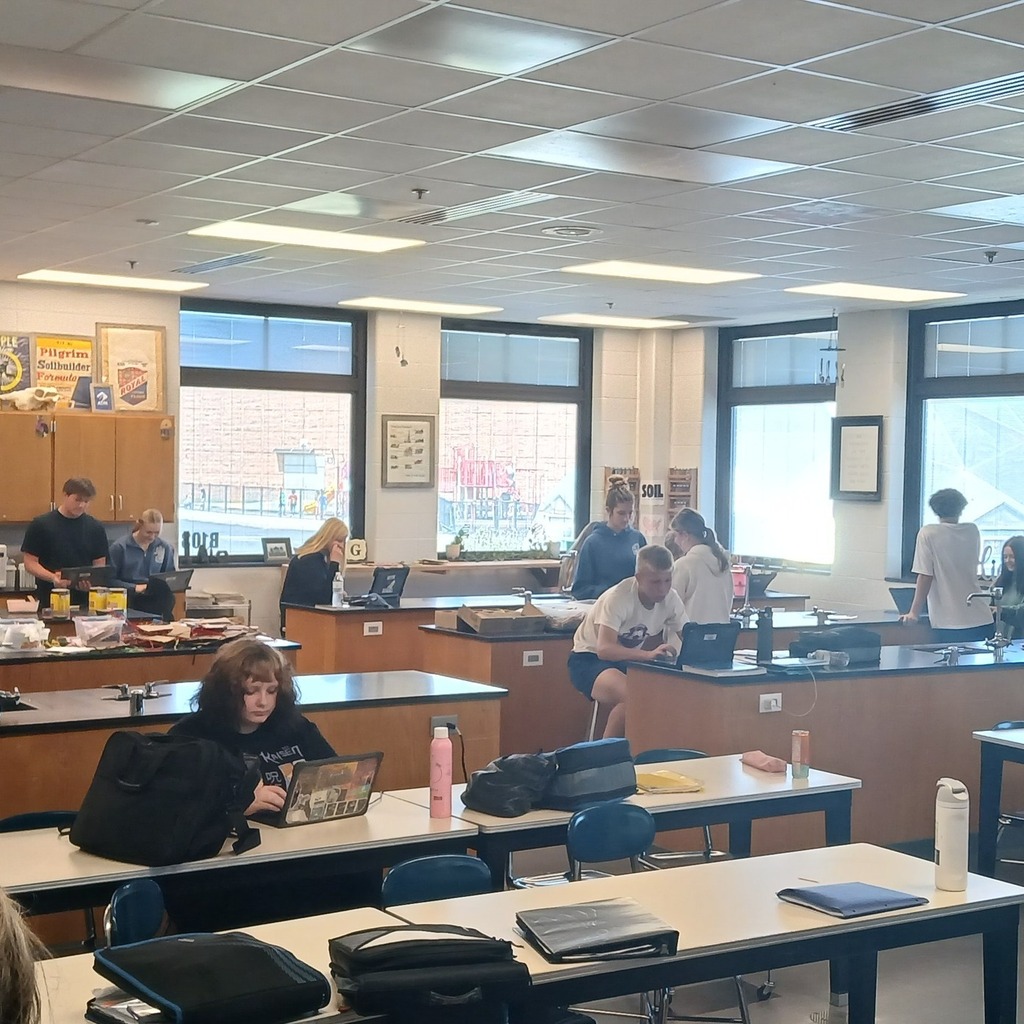 South Dearborn High School students collaborating on laptops in an agriculture classroom decorated with farm-themed decor.