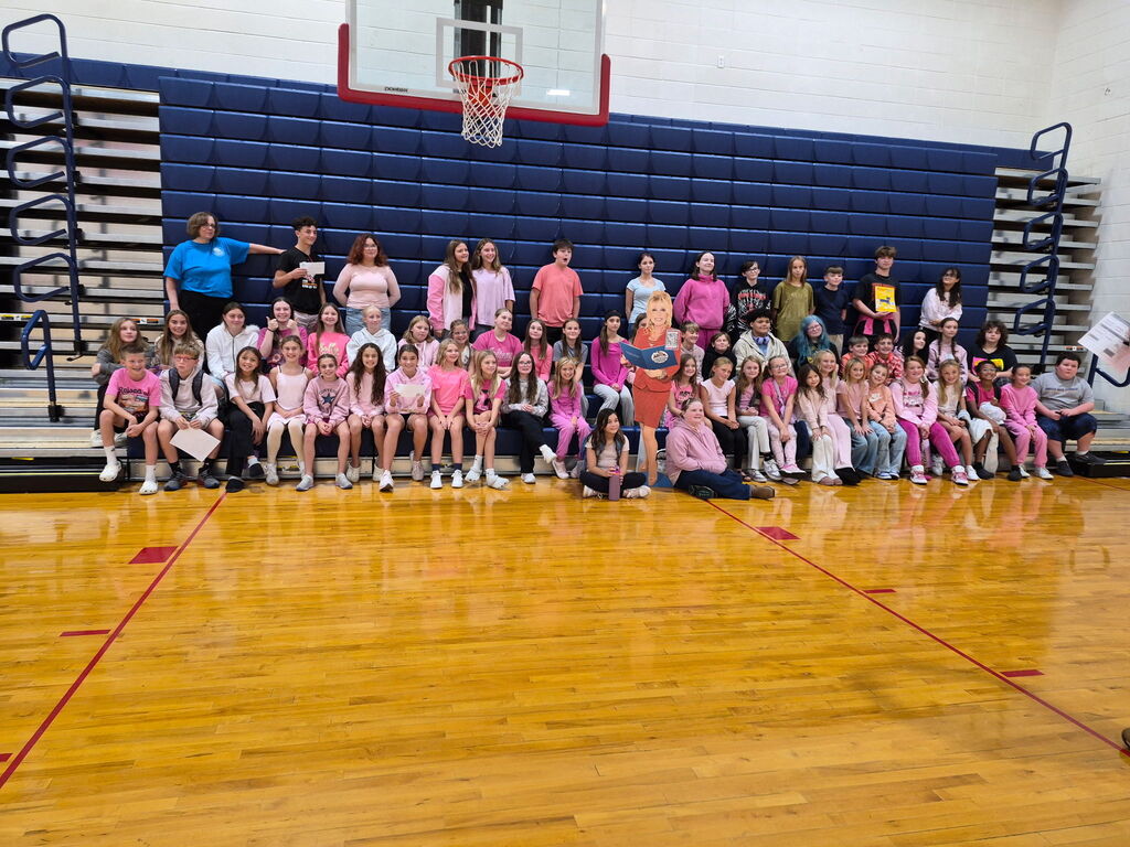 South Dearborn Middle School and Aurora Elementary students in pink shirts gathered in the gym with a Dolly Parton cutout for Wear Pink Day.