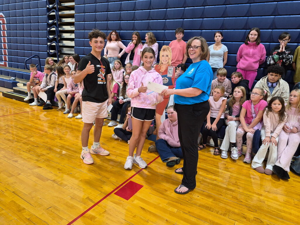 South Dearborn student leaders presenting a $1,000 donation check to an Imagination Library of Dearborn County representative during Wear Pink Day.