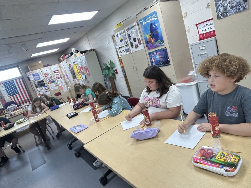 Aurora Elementary students sketching their South America art projects with colored pencils in Ms. Friedhoff's art class.