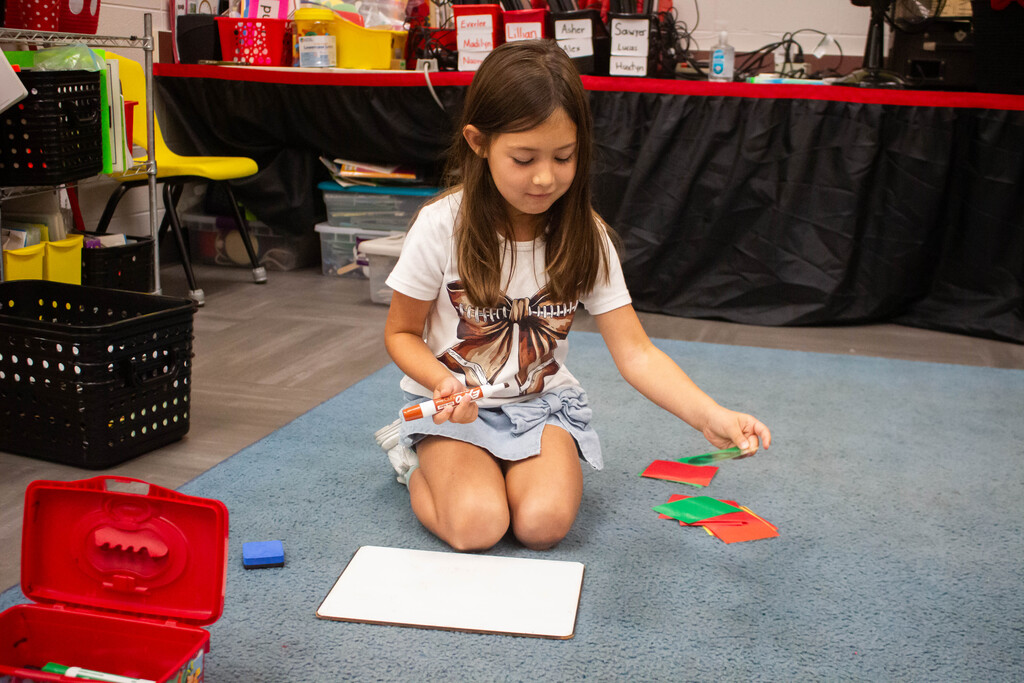 AES kindergarten students hone their literacy skills in apple-themed centers.