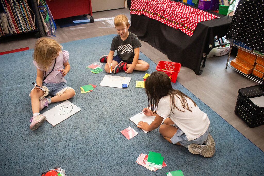 AES kindergarten students hone their literacy skills in apple-themed centers.