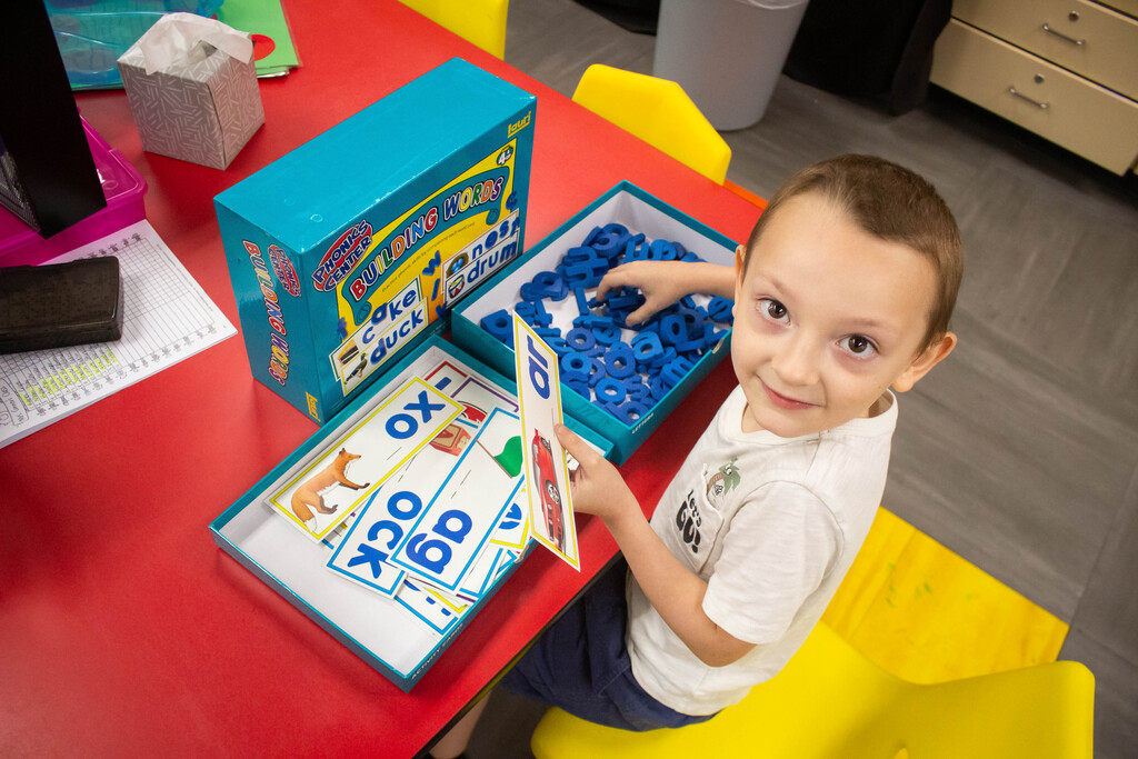 AES kindergarten students hone their literacy skills in apple-themed centers.