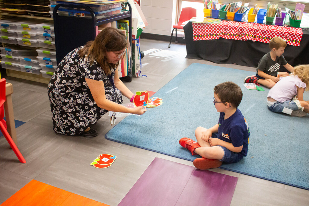 AES kindergarten students hone their literacy skills in apple-themed centers.