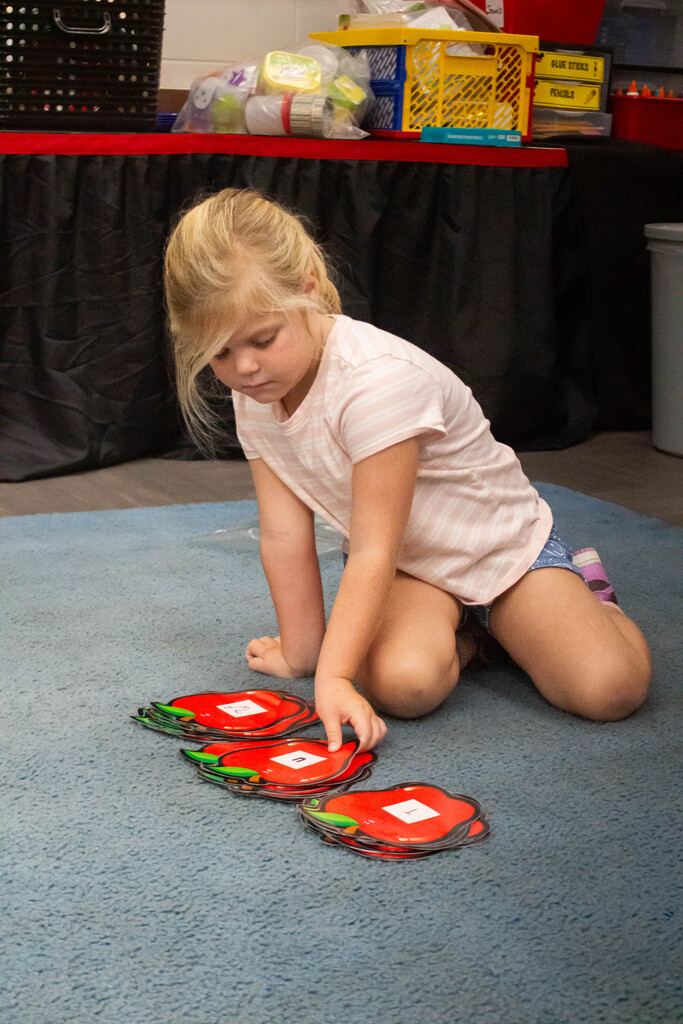 AES kindergarten students hone their literacy skills in apple-themed centers.