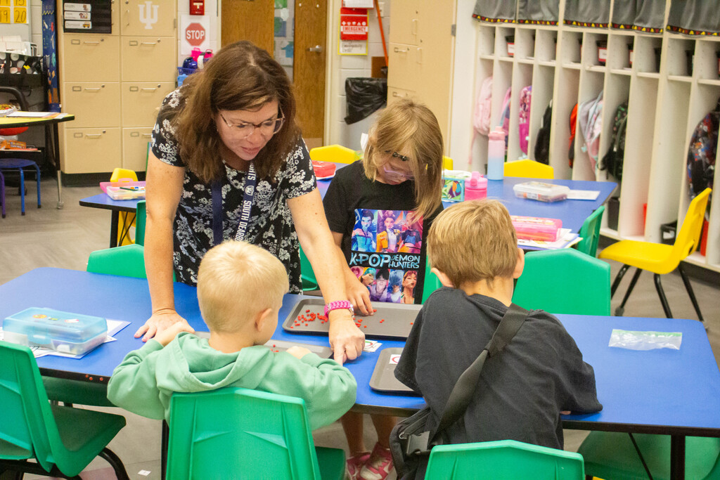 AES kindergarten students hone their literacy skills in apple-themed centers.
