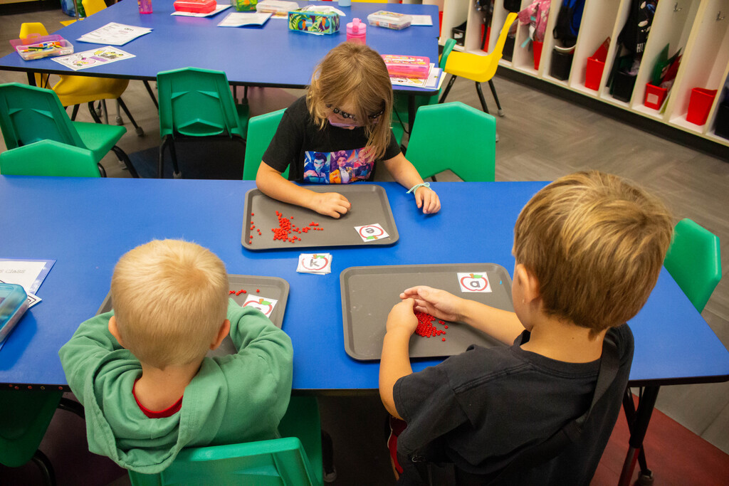 AES kindergarten students hone their literacy skills in apple-themed centers.
