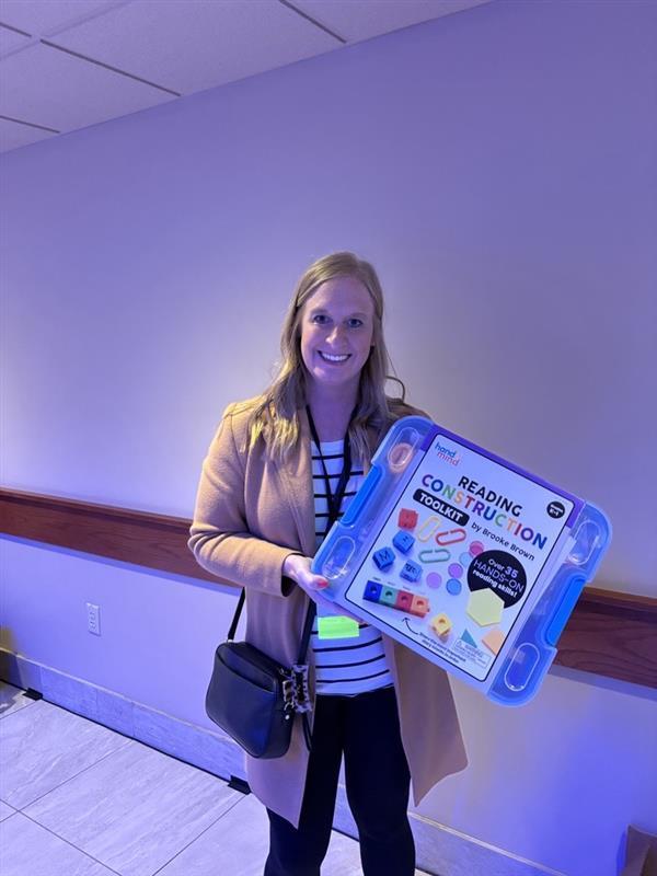 teacher holding doorprize