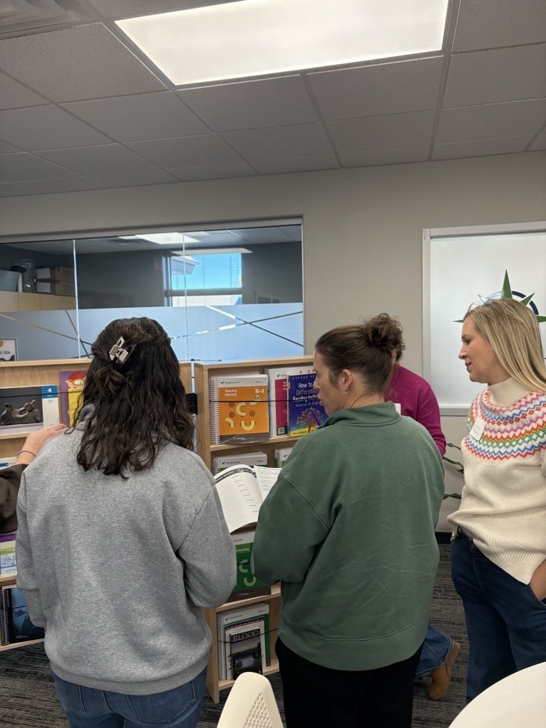 group of teachers looking at books