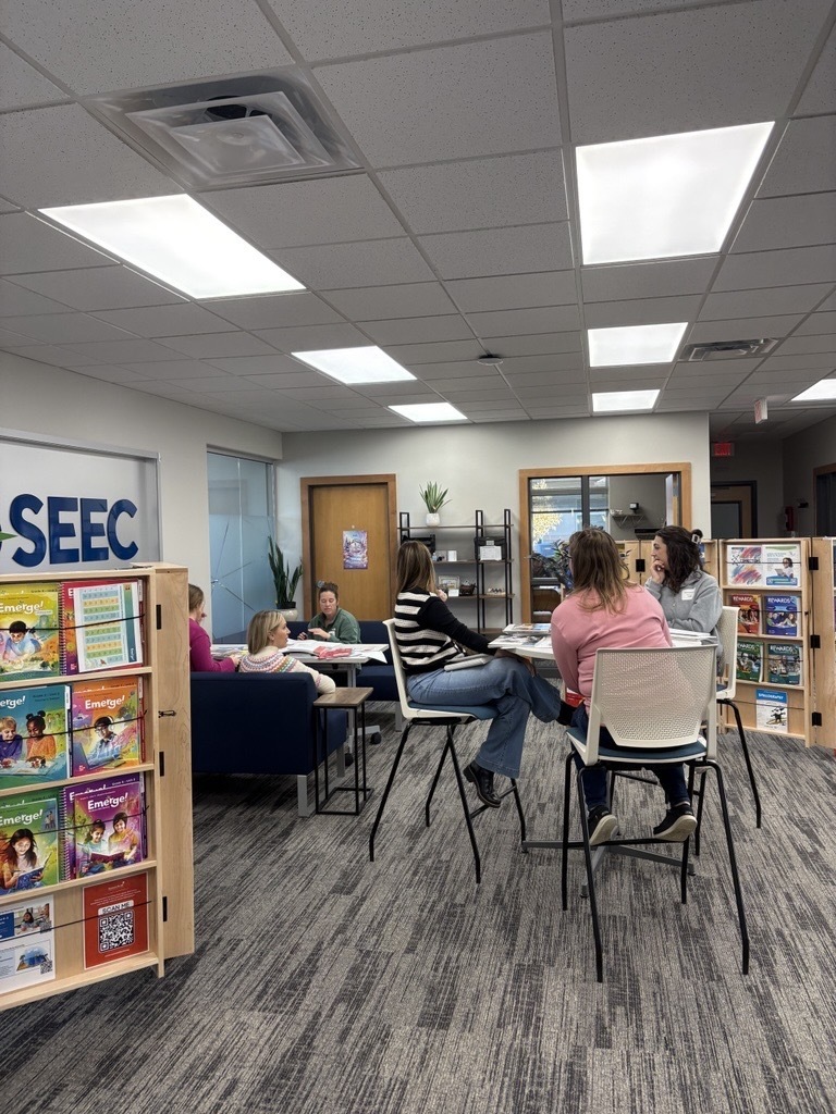 teachers sitting at tables and talking