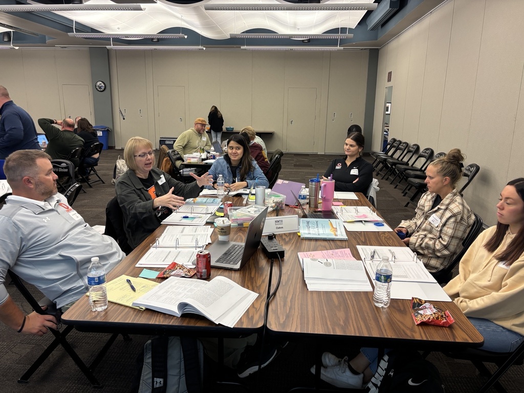 group of educators talking around two tables