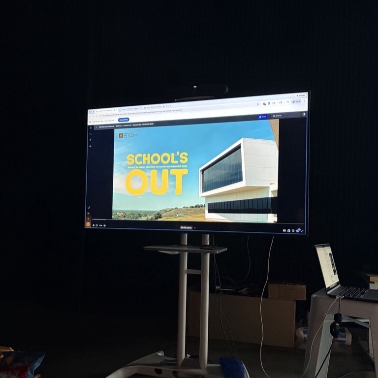 picture of a tv screen with the text school's out