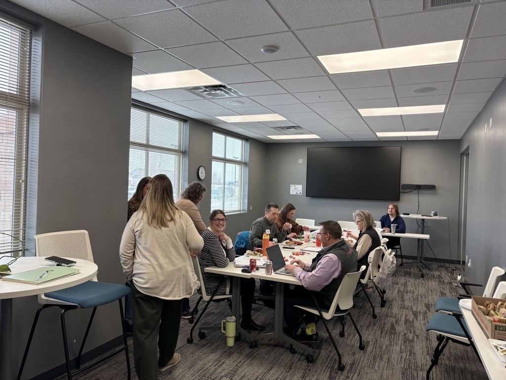 picture of people smiling around table