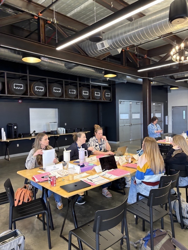group of educators talking around table