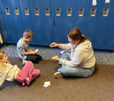 adult using flashcards with students