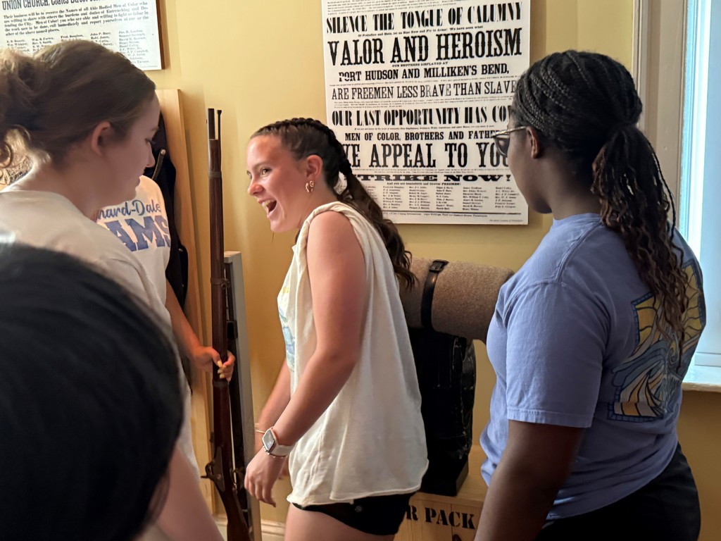 Students learning from a tour guide at Gettysburg.