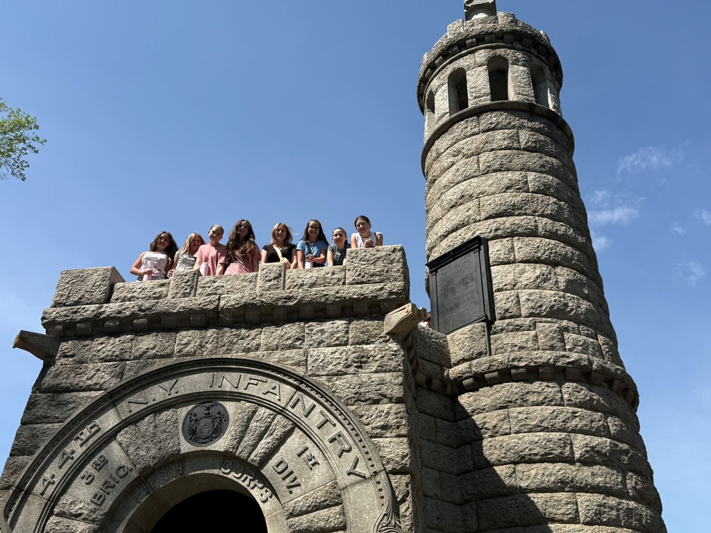 A group of students looking down from the 44th NY Infantry Monument at Gettysburg.