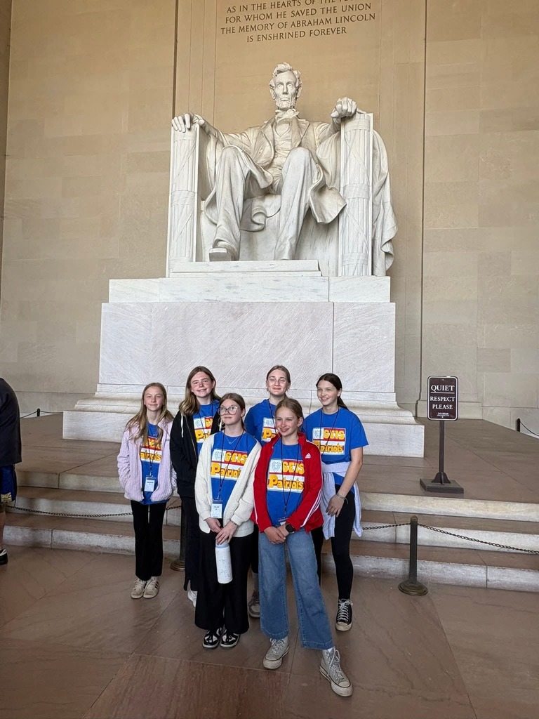 A group of 6th grade students from SEIS posting in front of the statue of Abraham Lincoln at the Lincoln Memorial in Washington D.C.