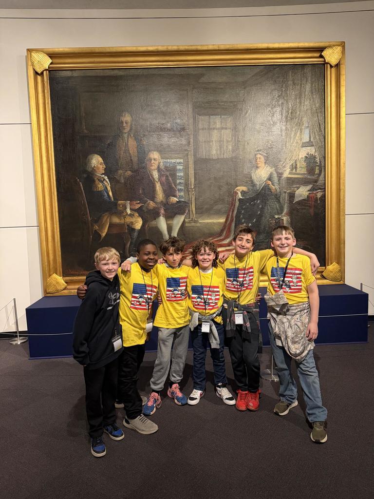 A group of 5th grade students from SEIS posting in front of a painting at the Harrisburg Capitol Building.