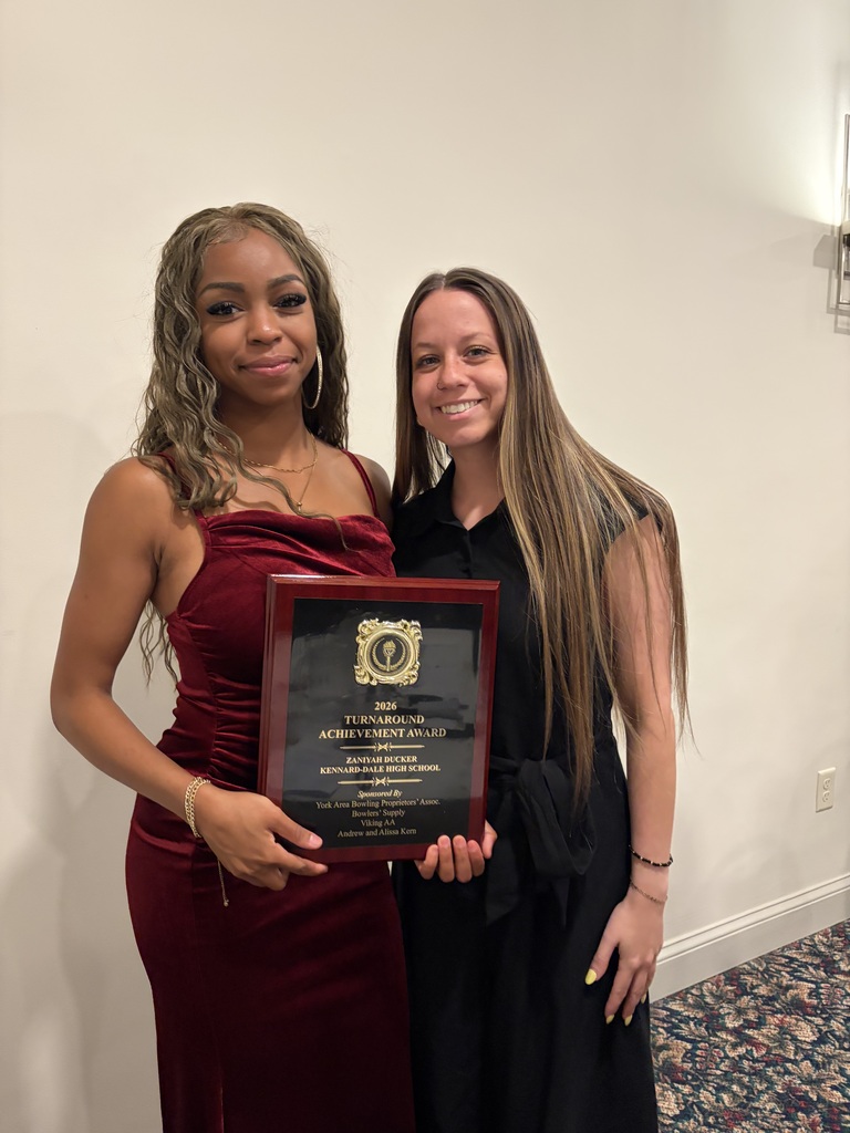Zaniyah posing with her award and Molly Devine, district social worker.