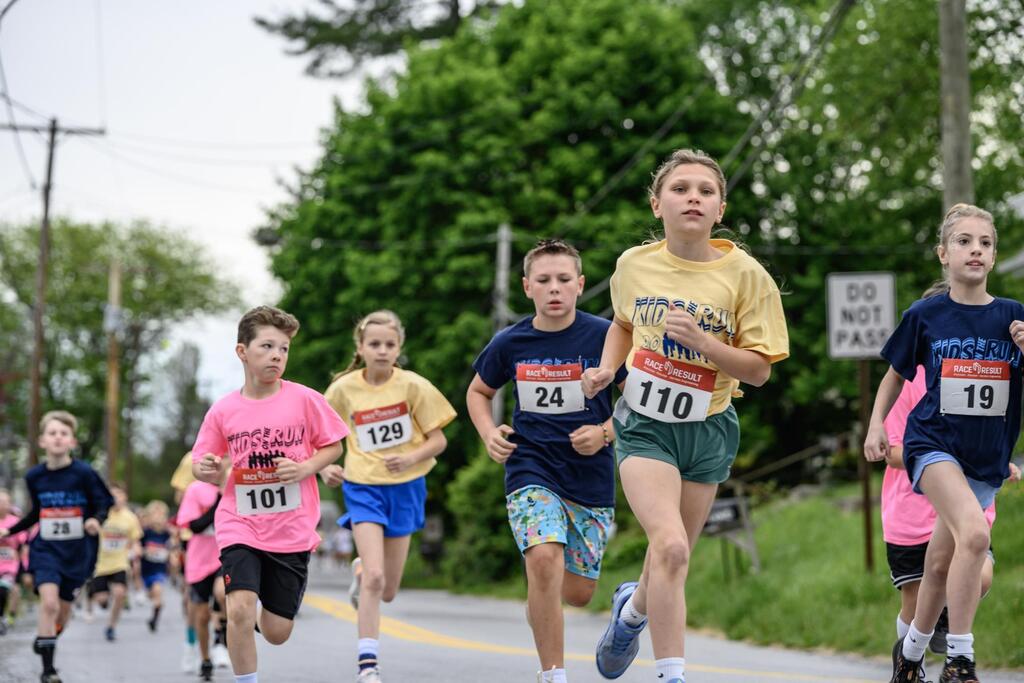 A group of students all in mid stride running the Kids on the Run 5K in Delta, PA.
