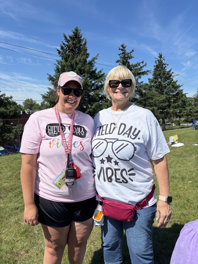 Two adults wearing t-shirts that say "Field Day Vibes" 