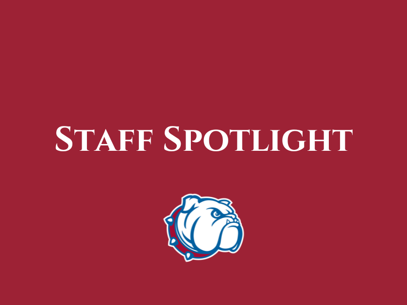 A graphic with the text "STAFF SPOTLIGHT" in white over a maroon background, accompanied by a bulldog mascot logo.