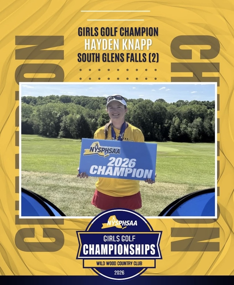Hayden Knapp stands on a grass field holding a blue sign reading "NYSPHSAA 2026 Champion"