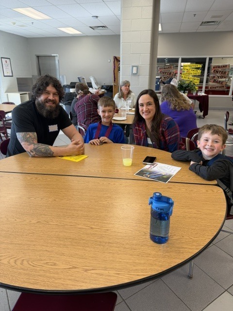 parents and students sitting at table