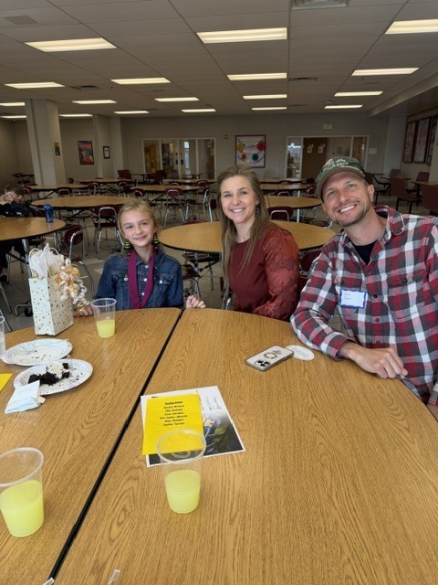 parents and student sitting at table