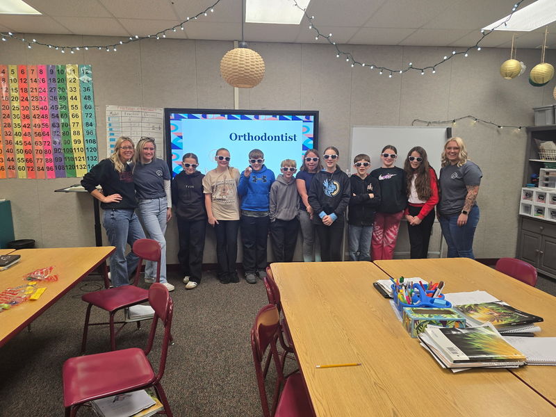students standing in front of a board