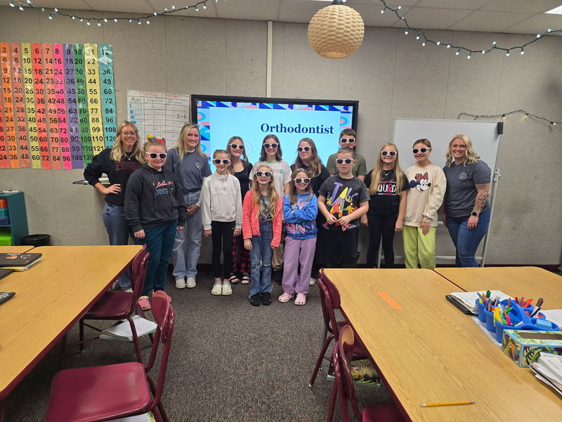 students standing in front of a board