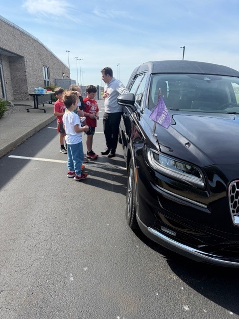students outside a car