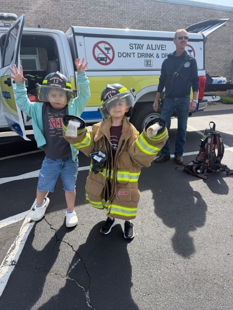 students in firefighter outfit