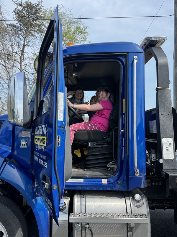 students climbing in trucks