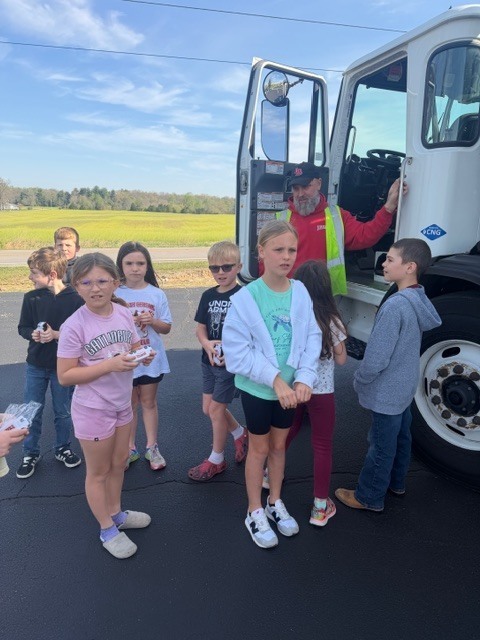 students outside a truck