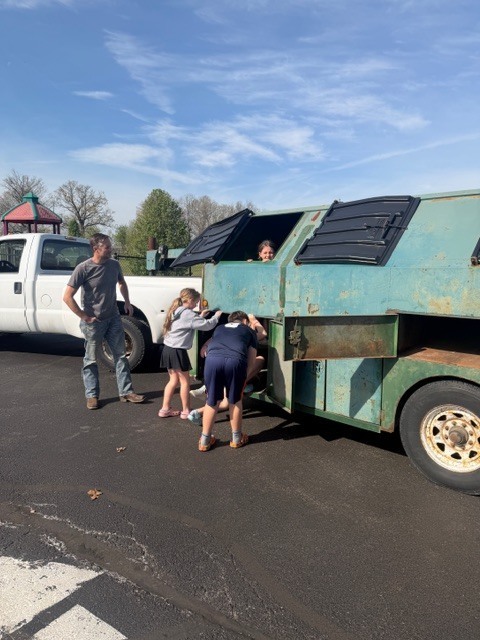 students outside a truck