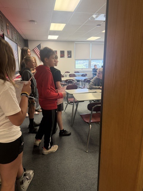 students standing in a jr high classroom