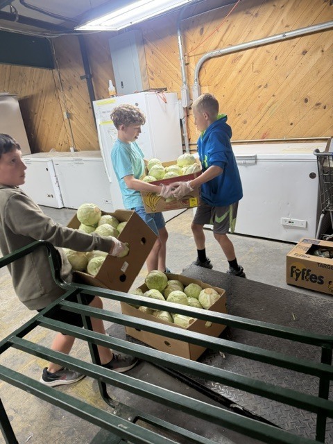 students carrying food at a pantry