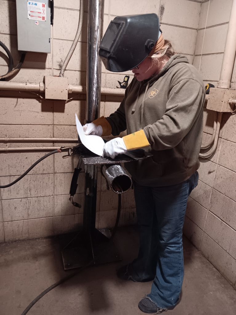 Samantha Berry (South Harrison) double checks her welding symbol information before completing her GMAW project