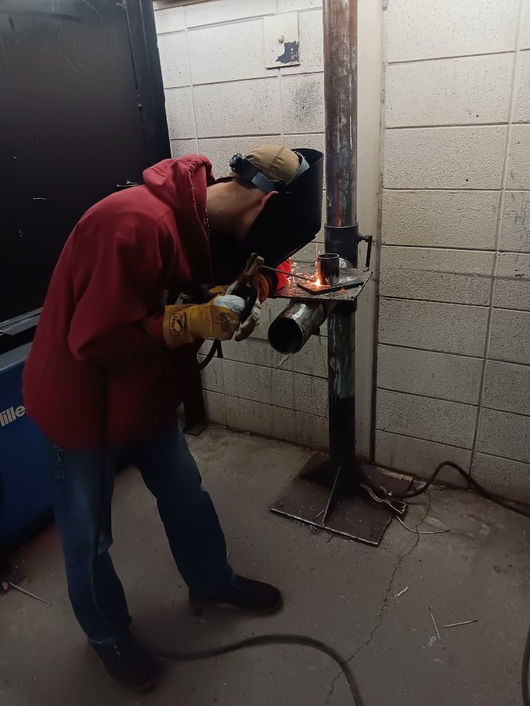 Koltyn Hancock (Gilman City) strikes an arc with some E7018 on his pipe to plate joint