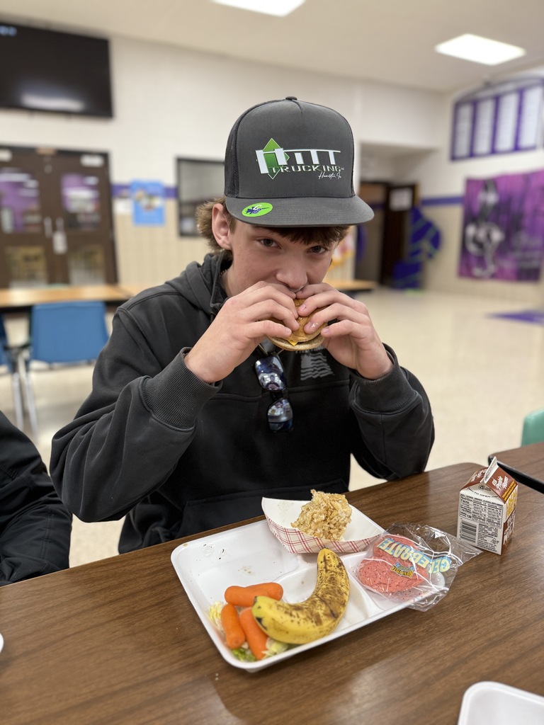 Gentry takes a big bite of burger during A lunch
