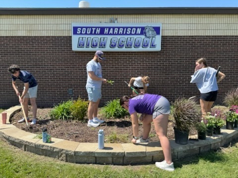 South Harrison National Honor Society students working in the flower bed in front of the high school in honor of Earth Day and ahead of the Academic Awards Ceremony.