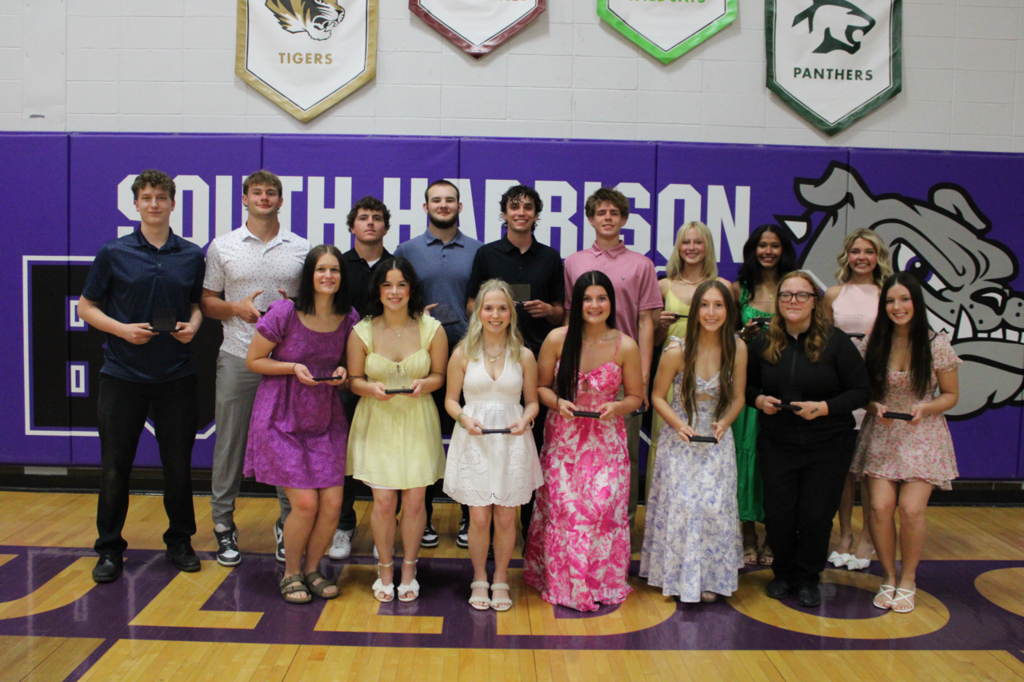 Group of senior students posing together while holding their awards, recognized as four-year Academic Banquet recipients.