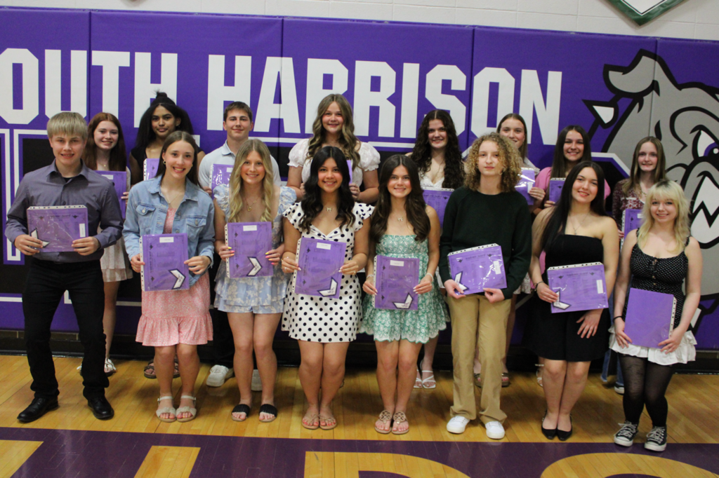 Sophomore students gathered together, holding their academic certificates and chevrons at the Academic Banquet.