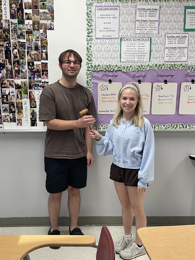 Lane Wedgworth accepts the gavel from Josie Taylor during the student council end-of-year breakfast, symbolizing the transition of leadership.