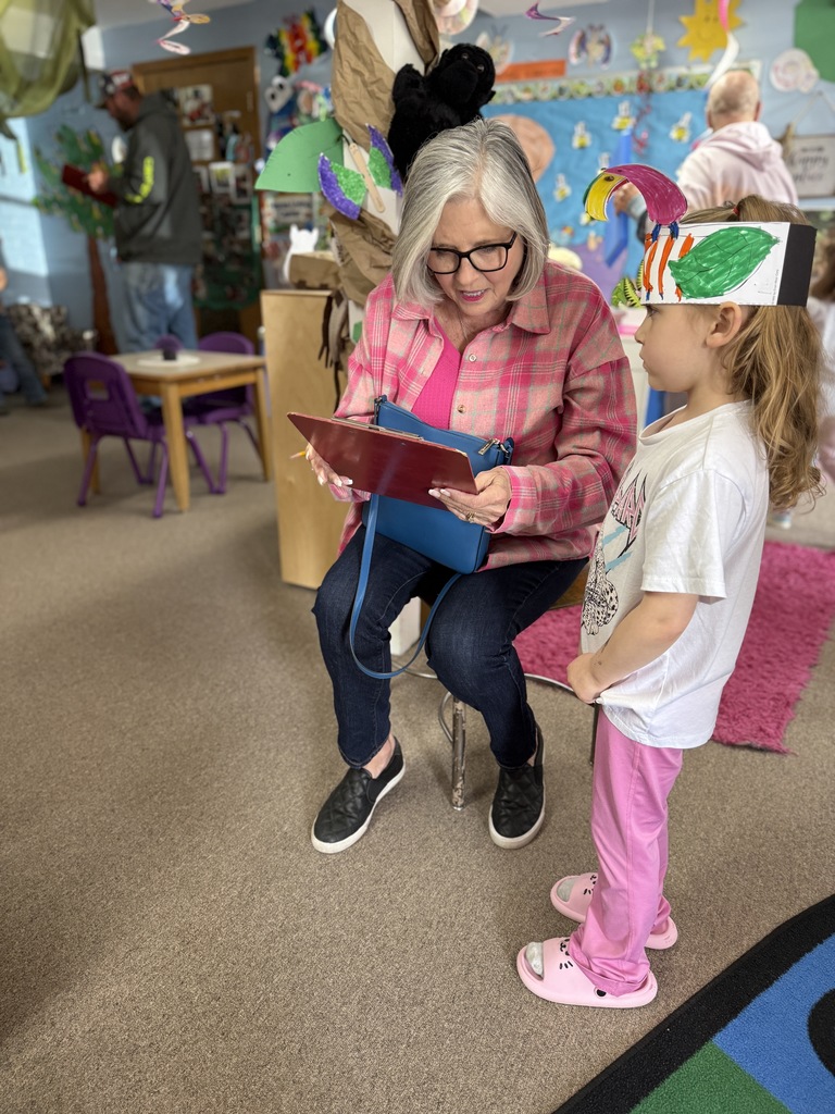 Mrs. Smith goes through the checklist of all the rainforest animals with a preschooler.